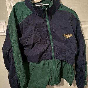 Vintage Reebok Blue and Green windbreaker 90s, with a buttoned up hood option